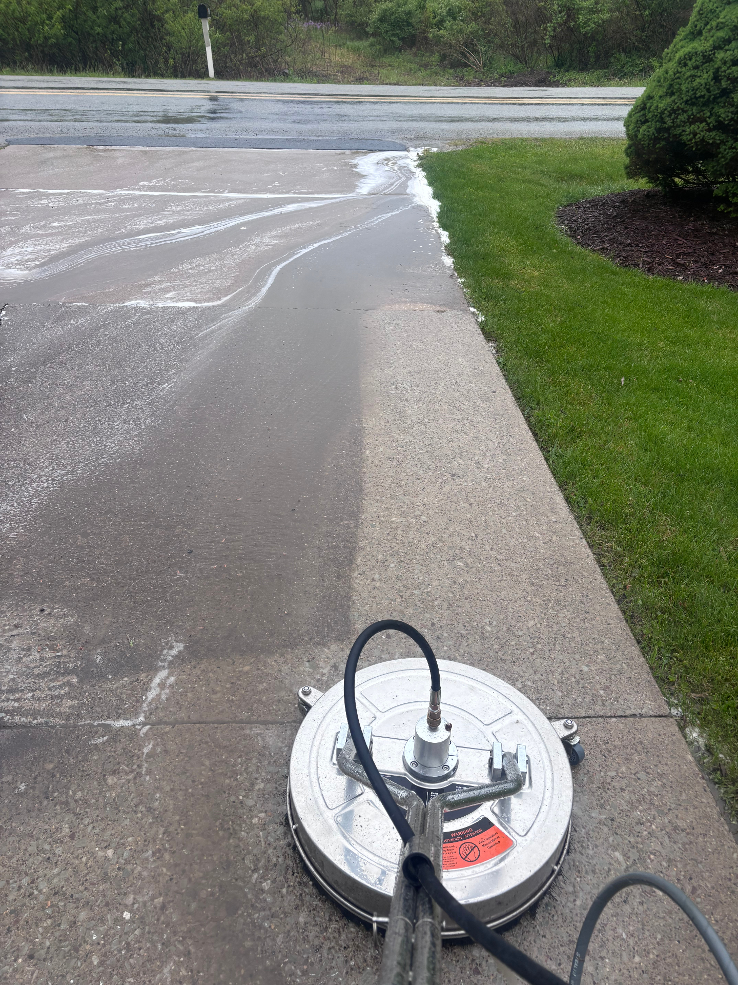 Driveway being cleaned with a surface cleaner
